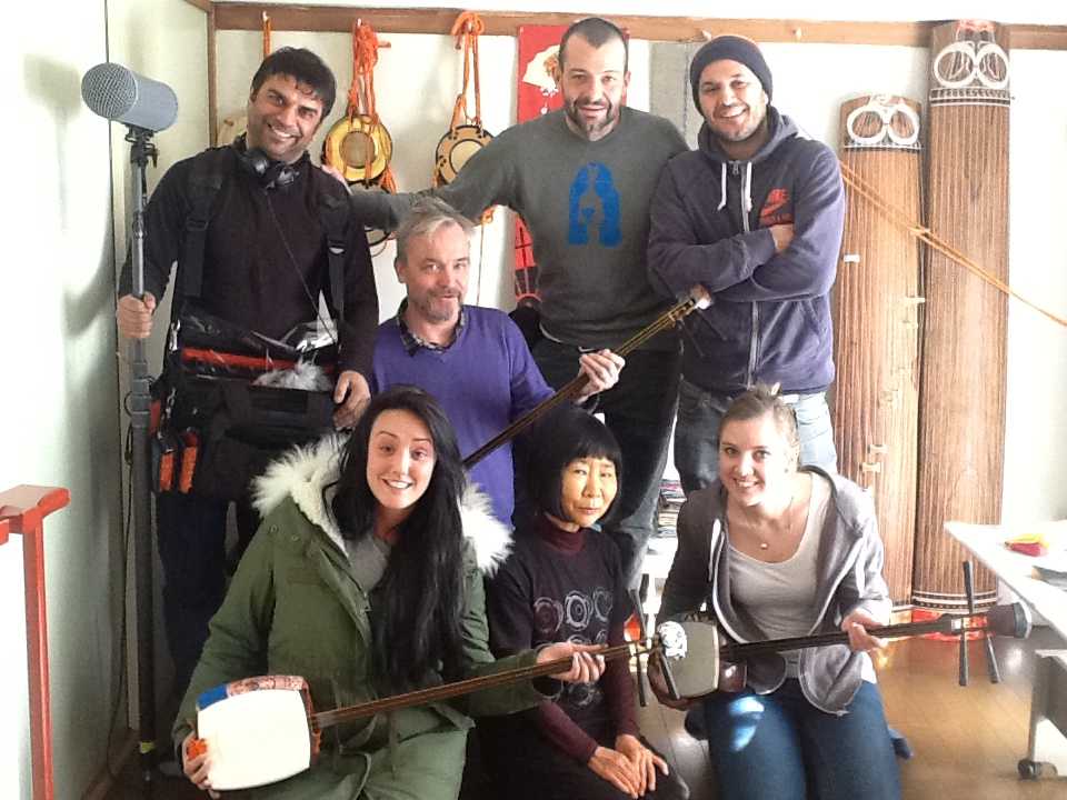 Group photo of the BBC visit to Japan to inverview Makoto Nishimura. They are holding shamisen.