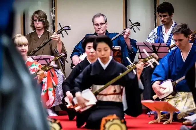 Students in kimono perform a shamisen recital